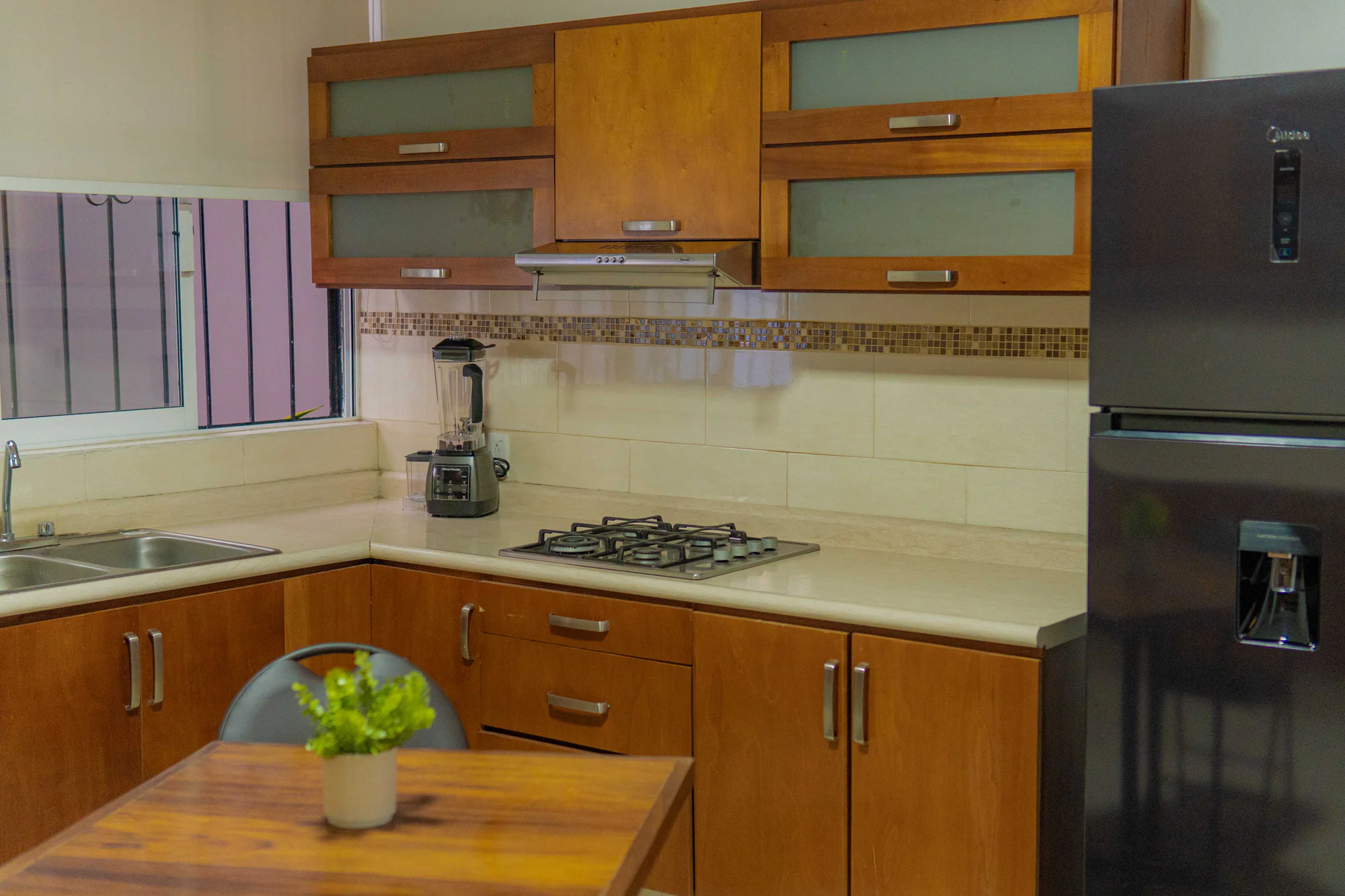 Cocina de Los Olivos con muebles de madera y mesa